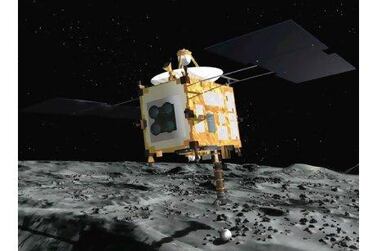 The Hayabusa probe collects surface samples after landing on an asteroid in an artist's rendering