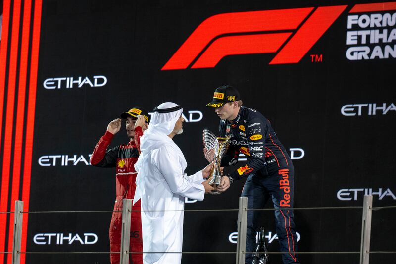 Sheikh Khaled bin Mohamed presents the trophy to the Formula 1 Etihad Airways Abu Dhabi Grand Prix winner Max Verstappen of Red Bull on the podium. Photo: Mohamed Al Hammadi / UAE Presidential Court