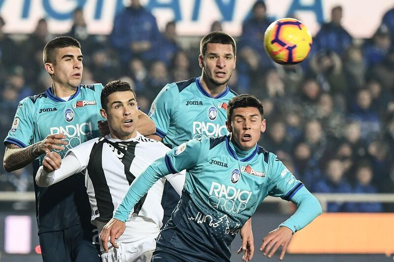 Juventus' Portuguese forward Cristiano Ronaldo (2ndL) eyes the ball being centred during the Italian Serie A football Match Atalanta Bergamo vs Juventus at the Atleti Azzurri d'Italia stadium in Bergamo.  AFP