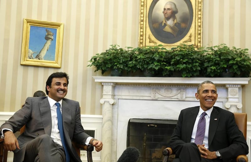 US president Barack Obama and the Emir of Qatar Sheikh Tamim bin Hamad Al Thani smile while in the Oval Office at the White House on February 24, 2015. Larry Downing/ ٍReuters