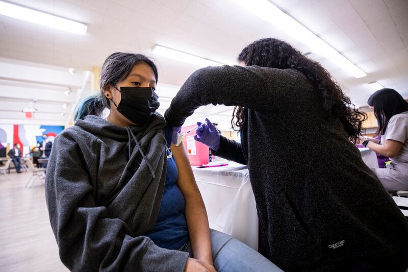 A 13-year old receives a dose of the Pfizer Covid-19 vaccine at a clinic in Los Angeles. EPA