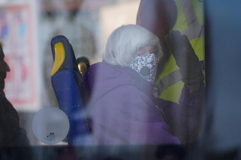 An elderly resident evacuated from the care home waves from a bus in Northwich. Getty Images