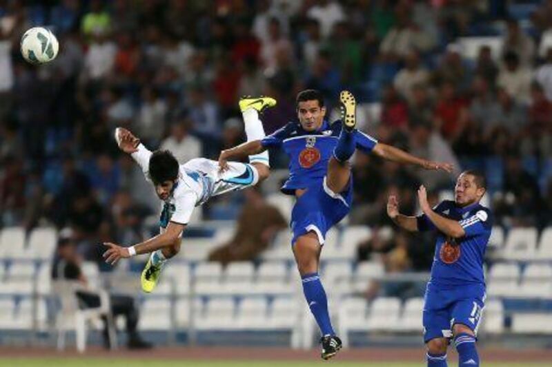 Baniyas' Sultan Al Ghaferi goes flying in his challenge on Al Khor's Brazilian striker Bruno Mineiro.