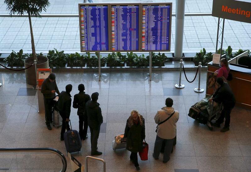 People gather in front of an information board at Domodedovo airport outside Moscow on November 6, 2015. President Vladimir Putin ordered the suspension of all passenger flights to Egypt on Friday until the cause of a deadly plane crash was established. Maxim Zmeyev/Reuters