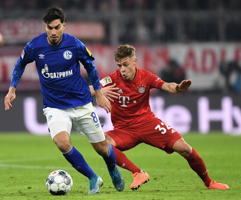 Bayern Munich's midfielder Joshua Kimmich (R) and Schalke's Turkish midfielder Suat Serdar (L) vie for the ball during the German first division Bundesliga football match Bayern Munich v Schalke 04 in Munich on January 25, 2020. (Photo by Christof STACHE / AFP) / DFL REGULATIONS PROHIBIT ANY USE OF PHOTOGRAPHS AS IMAGE SEQUENCES AND/OR QUASI-VIDEO