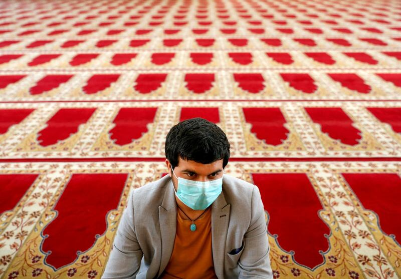 An Afghan man wearing a protective face mask takes part in prayers during Eid Al Fitr. Reuters