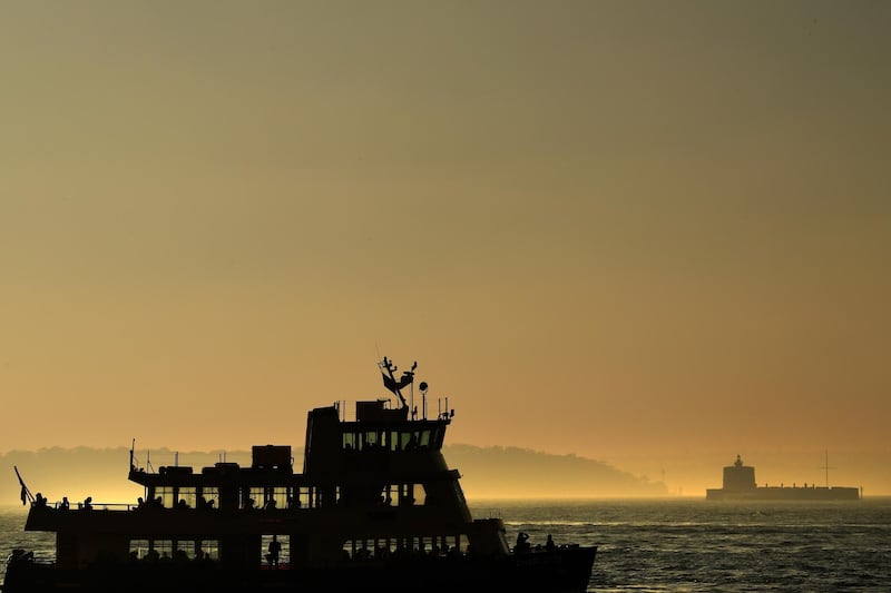 A commuter ferry moves through the thick smoke blanketing Sydney Harbour in Sydney, Australia.
