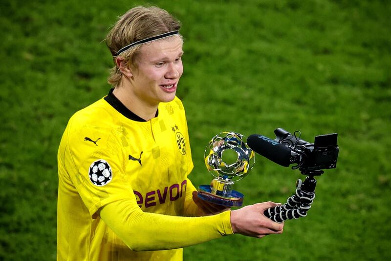 Dortmund's Erling Haaland poses with theman-of-the-match award. EPA