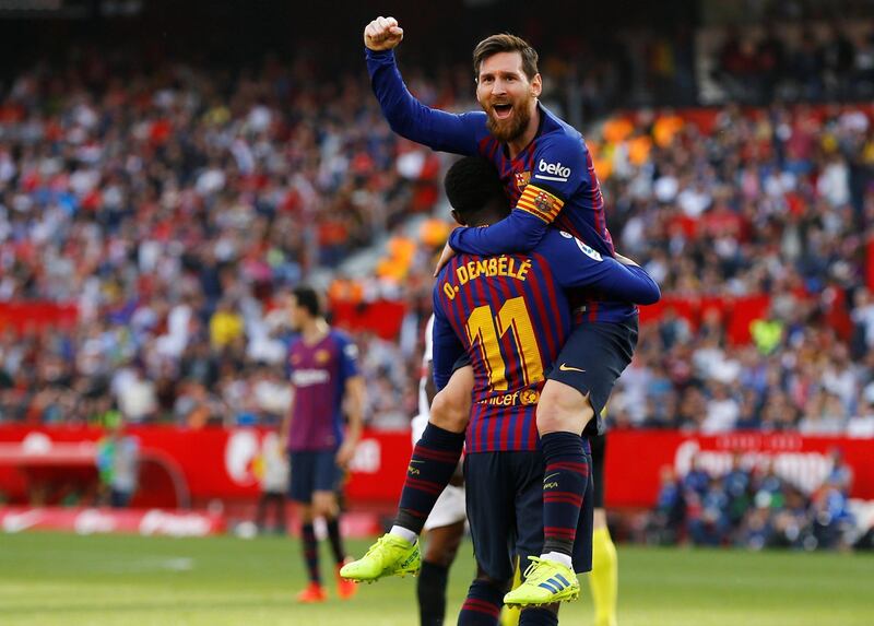 Barcelona's Lionel Messi celebrates scoring their second goal with Ousmane Dembele. He would score a hat-trick as they won 4-2.  Reuters