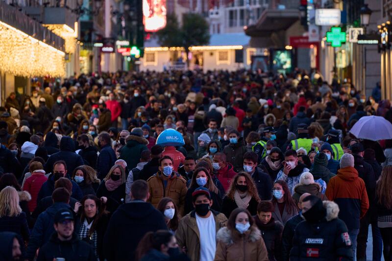 People wearing face masks in central Madrid. Spain's prime minister is urging people to 'remain prudent' over the holidays. AP Photo