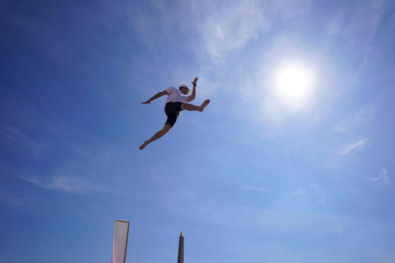 A man jumps as he takes part in the "Journee Olympique" ("Olympic day") in Paris. A total of thirty Olympic and paralympic sports will be presented on Place de la Concorde in Paris.  APF