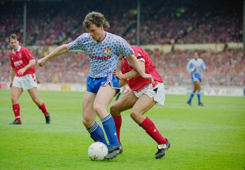 Mark Hughes of Manchester Utd holds onto the ball from the Nottingham Forest defender Des Walker during their Rumbelows Football League Cup Final match on 12 April 1992 at Wembley Stadium, London, United Kingdom. Manchester Utd F.C. won 1-0.  (Photo by Simon Bruty/Hulton Archive/Getty Images).
