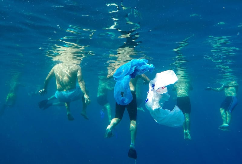 Plastic bags float as swimmers prepare to emulate sea creatures in the Mediterranean Sea on the Beirut coastline, Lebanon, in an effort to send a message that pollutants such as bottles and plastic bags will entangle marine animals. AP Photo