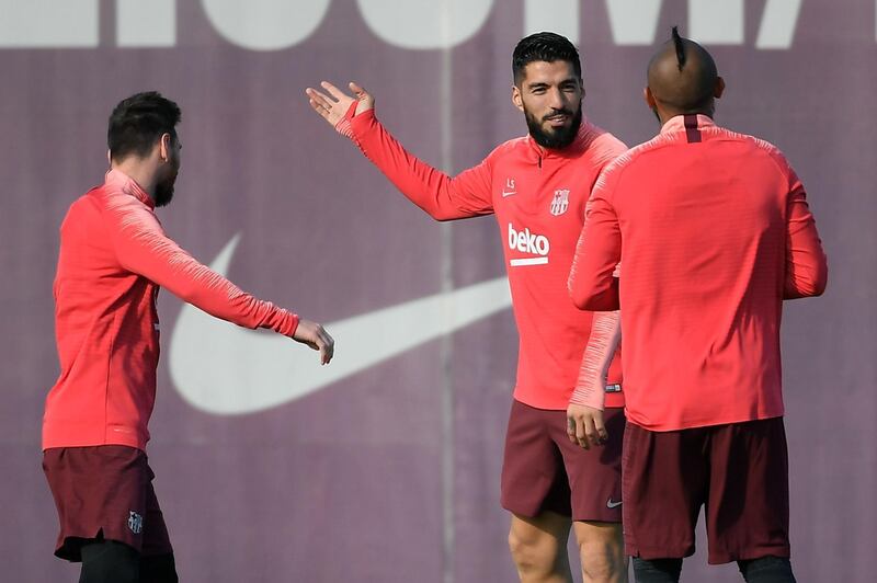 Lionel Messi, Luis Suarez and Arturo Vidal is conversation during the training session. AFP