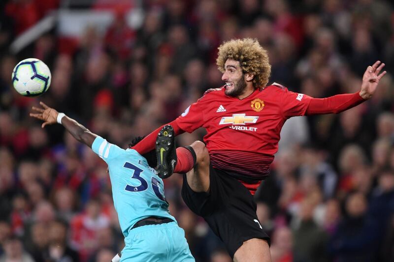 Newcatsles United's Christian Atsu and Manchester United's Marouane Fellaini battle for possession. Getty Images