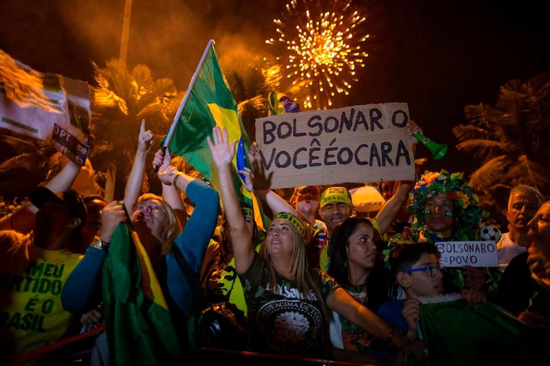 Supporters of far-right presidential candidate Jair Bolsonaro celebrate in front of his house in Rio de Janeiro, Brazil. AFP