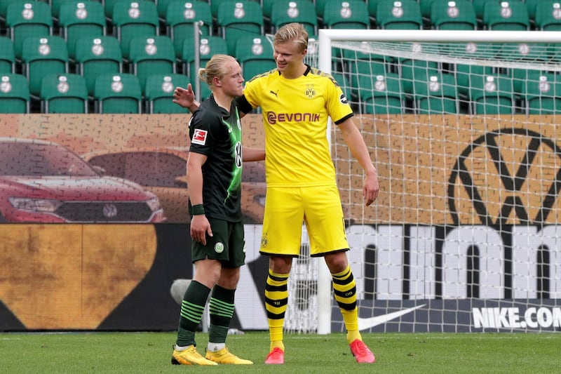 Borussia Dortmund's Erling Haaland greets Wolfsburg's Xaver Schlager. Reuters