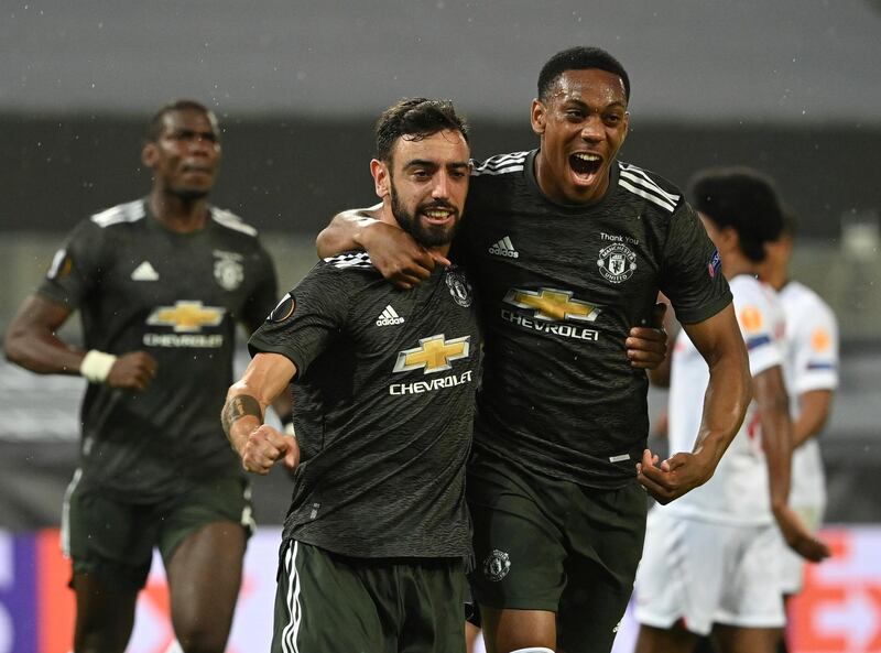 Manchester United's Bruno Fernandes, left celebrates after scoring the opening goal of the game. AP
