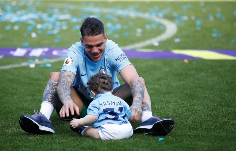 Manchester City's Ederson celebrates with his daughter after winning the Premier League title. Carl Recine / Action Images via Reuters