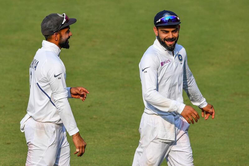 India captain Virat Kohli, right, celebrates after the match. AFP