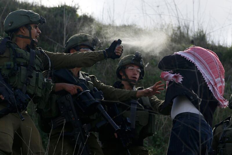 Israeli soldiers use pepper spray on a Palestinian demonstrator near a Jewish settlement Yitzhar, near the West Bank city of Nablus. AP Photo