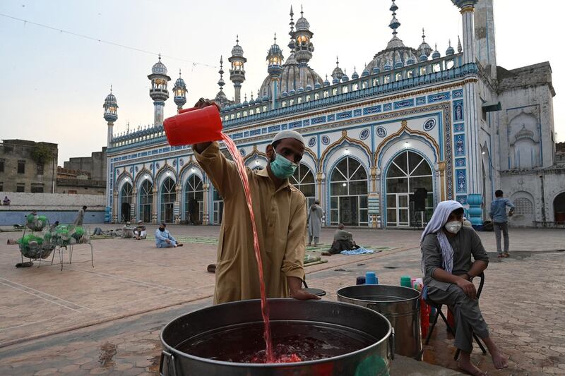 A volunteer prepares sweet drinks for devotees before they break their fast at the Jamia Mosque in Rawalpindi, Pakistan. AFP