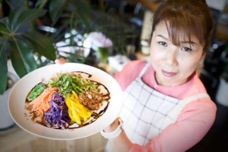 Mayumi Nishimura, who believes we should eat whole grains and local vegetables and argues that food should be chewed 30 times, holds up a soba salad.