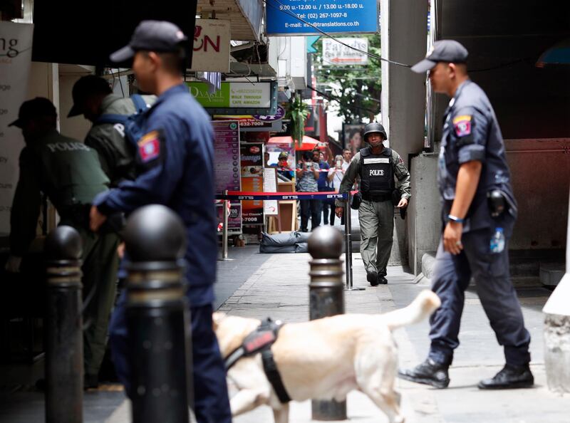 Members of the Explosive Ordnance Disposal (EOD) unit and policemen secure the area to inspect a suspicious object on Silom road in Bangkok, Thailand.  EPA