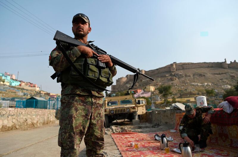 An Afghan National Army (ANA) soldier stands during the Eid al-Adha festival near the old fortress of Bala Hissar in Kabul on August 11, 2019. Afghans have started celebrating Eid al-Adha or "Feast of the Sacrifice", which marks the end of the annual Hajj or pilgrimage to Mecca and is celebrated in remembrance of Abraham's readiness to sacrifice his son to God. / AFP / WAKIL KOHSAR
