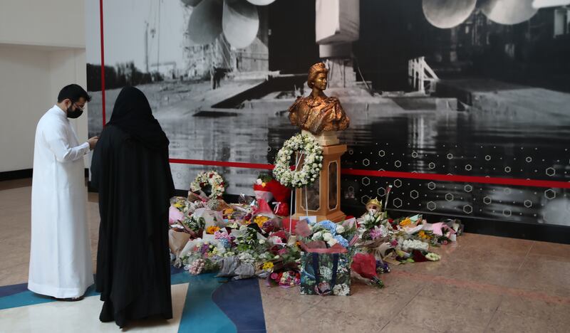 Flowers are laid near a statue of the queen inside the retired ocean liner 'Queen Elizabeth Two', docked at Port Rashid in Dubai. EPA