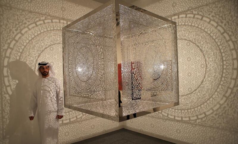 Art fan Ahmed al Abdouli inspects artist Anila Quayyum Agha’s Crossing Boundaries installation at Manarat Al Saadiyat in Abu Dhabi. The work is being shown as part of the seventh annual Abu Dhabi Art event. Ravindranath K / The National