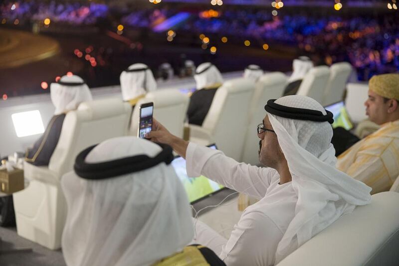 Sheikh Khaled bin Mohammed (C) takes a photo of the 44th UAE National Day celebrations at Zayed Sports City. Mohamed Al Hammadi / Crown Prince Court - Abu Dhabi