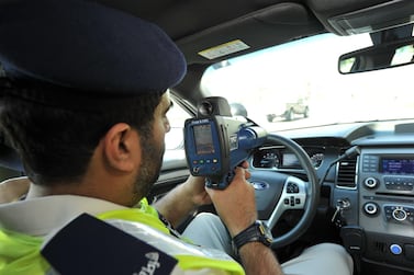 A policeman holding a speed gun. Courtesy: Abu Dhabi police.