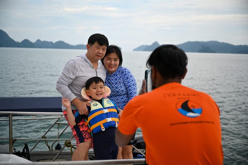 A family enjoy a catamaran yacht trip in Langkawi. Photo: AFP.