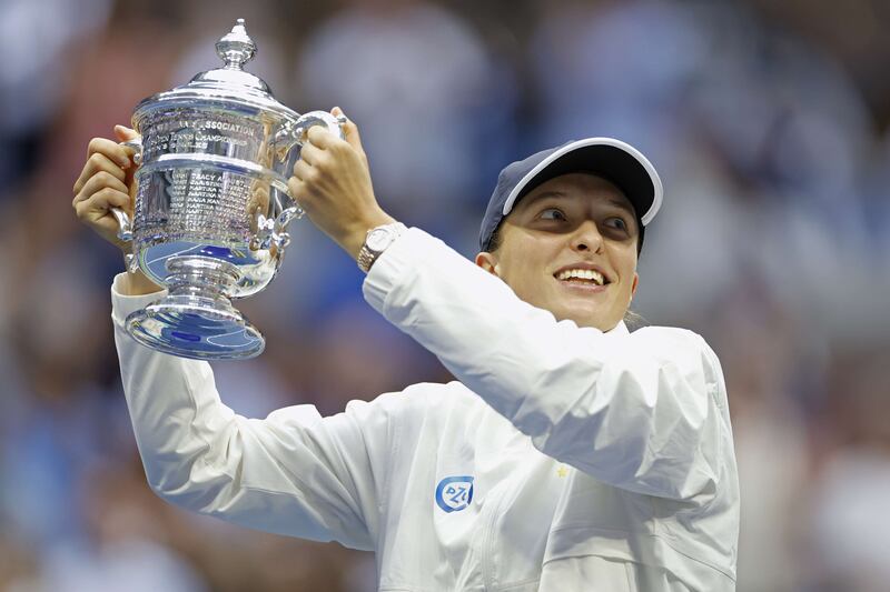 Iga Swiatek celebrates with the championship trophy after winning the 2022 US Open. Getty