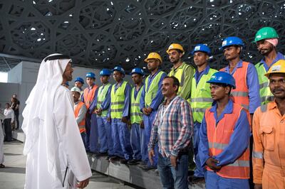 SAADIYAT ISLAND, ABU DHABI, UNITED ARAB EMIRATES - September 11, 2017: HH Sheikh Mohamed bin Zayed Al Nahyan, Crown Prince of Abu Dhabi and Deputy Supreme Commander of the UAE Armed Forces (L), speaks with construction workers while touring the newly constructed Louvre Abu Dhabi. 
( Ryan Carter / Crown Prince Court - Abu Dhabi )
---