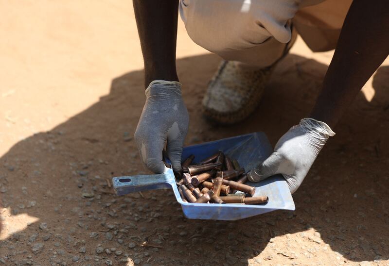 A forensics officer examines bullet casings from the scene. AFP