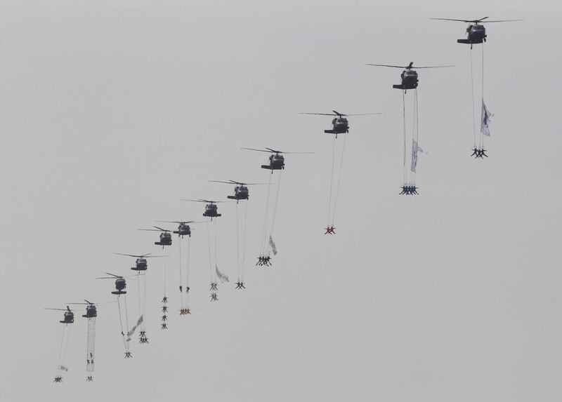 South Korean Special Forces soldiers hang from helicopters during the 65th anniversary of the Armed Forces Day. Ahn Young-joon / AP Photo