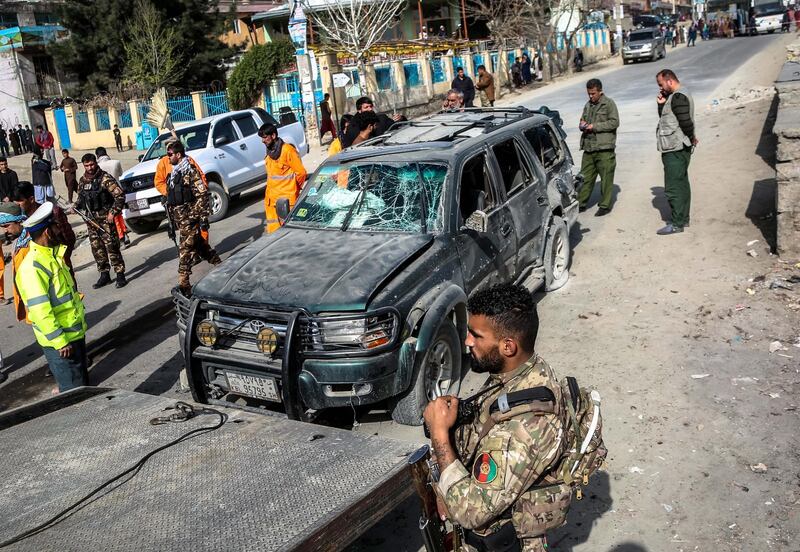 Security officials gather in the aftermath of a bomb explosion in Kabul, Afghanistan, on 18 March 2021. At least four people were killed and eleven others injured after a magnetic improvised explosive device (IED), targeting a minibus carrying employees of the Ministry of Communication and Information Technology, went off in Kabul. Hedayatullah Amid / EPA