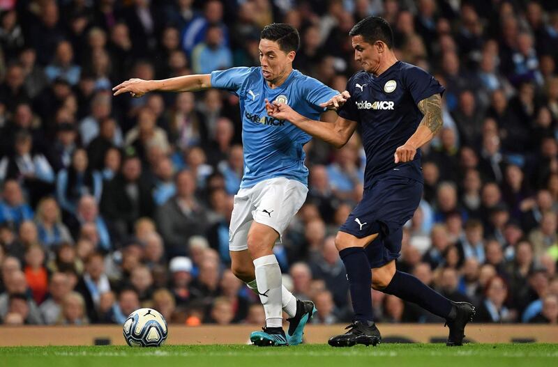 Manchester City Legend's French midfielder Samir Nasri  vies with Premier League All-stars XI's Tim Cahill. AFP