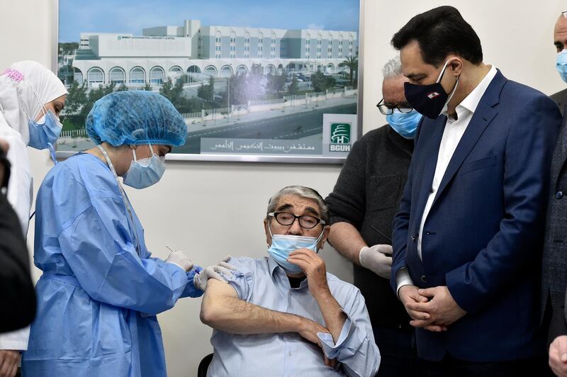 Lebanese artist Salah Tizani, 93, also known as Abou Salim, gets the Pfizer-BioNTech vaccine against coronavirus at Rafik Hariri University Hospital in Beirut on Sunday. EPA