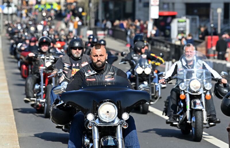 Members ride through London in March 2022. AFP