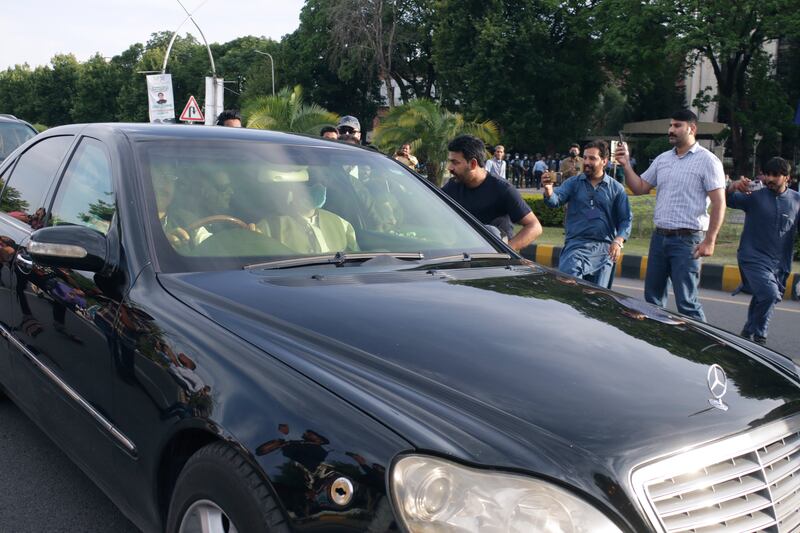 A car carrying Mr Khan arrives at the Supreme Court in Islamabad for his court appearance. AP