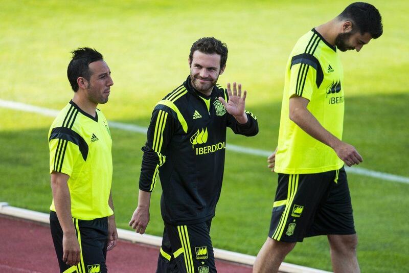 Juan Mata, centre, waves as he arrives at Monday's Spain training session for the 2014 World Cup. David Ramos / Getty Images / May 26, 2014