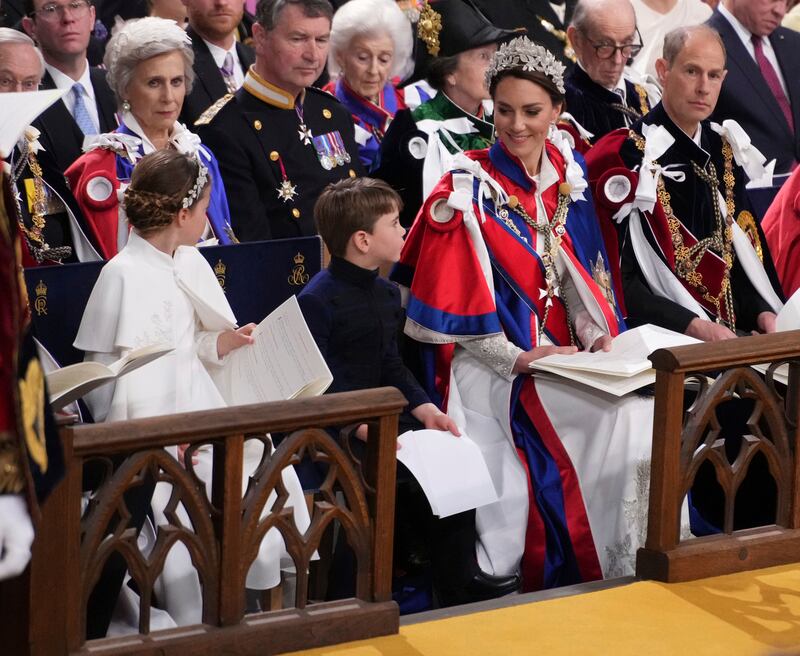 Princess Charlotte and Prince Louis with their mother, Kate. AP