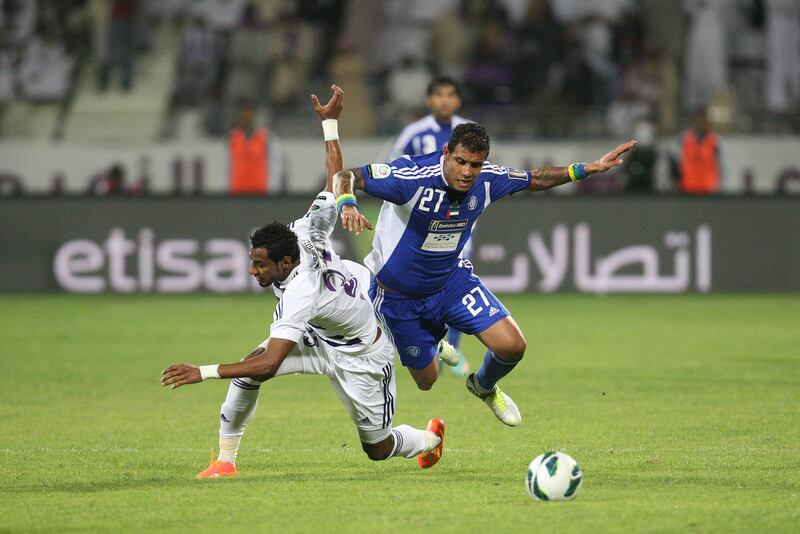 Dubai, United Arab Emirates, Dec 16 2012, Al-Maktoum Stadium Dubai, Al nasr v Al Ain- (right) Al Nasr's #27 Lima and Al Ain's#23 Mohamed Ahmed battle for the ball at midfield during action at Al-Maktoum Stadium in Dubai. Mike Young / The National??