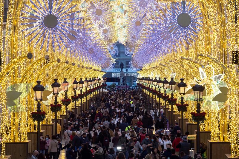 People watch the Christmas lighting in central Malaga, Spain. EPA