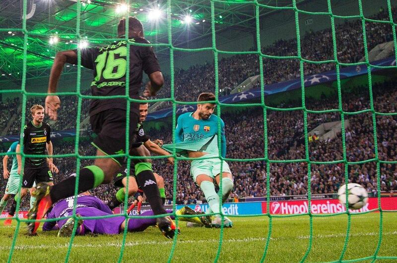 Barcelona’s Gerard Pique scores the winning goal past Borussia Monchengladbach goalkeeper Yann Sommer. Odd Andersen / AFP