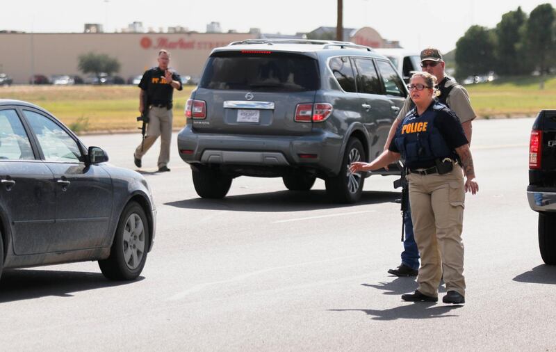 Authorities control traffic on the E. 42nd Street in Odessa, Texas. Several people were dead after a gunman who hijacked a postal service vehicle in West Texas shot more than 20 people, authorities said Saturday. The gunman was killed and a few law enforcement officers were among the injured. AP