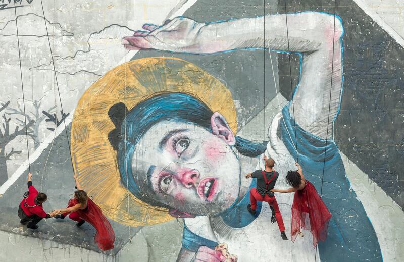Members of the Hungarian ensemble The Flock Project perform a 'wall dance' on the side of a house in Budapest. EPA